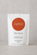 Dose packaging for ceremonial cacao discs on a gray background